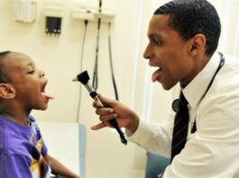 Doctor examines child's mouth
