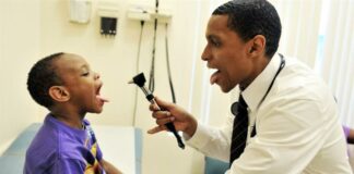Doctor examines child's mouth