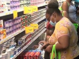 Female shopper examines goods at a supermarket.