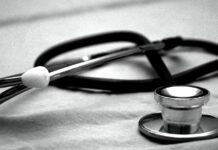 Black Stethoscope against white background.