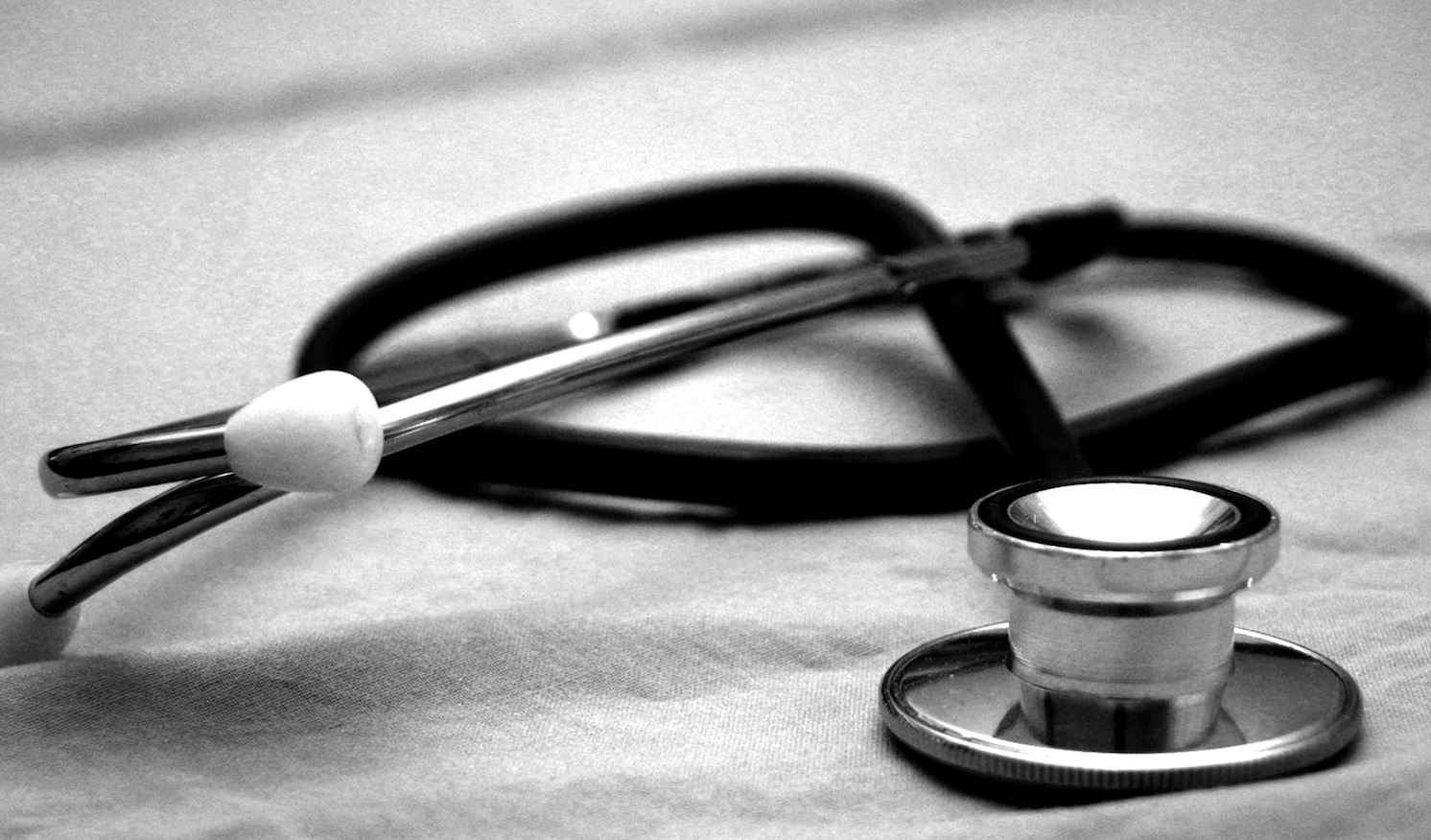 Black Stethoscope against white background.