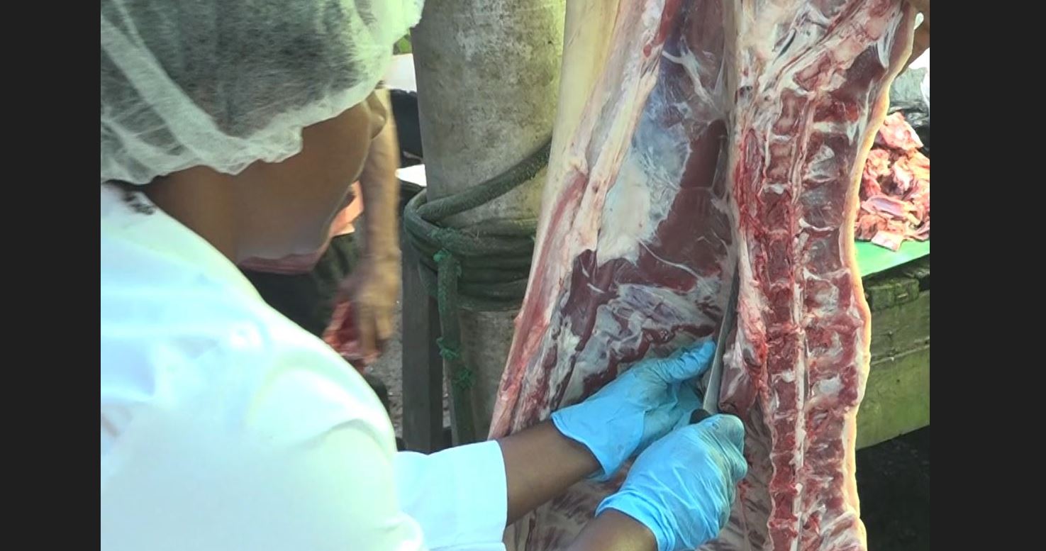 Butcher cutting meat.
