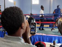 Spectators watch as young boxers take on each other in the ring at Saint Lucia boxing showcase.