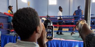 Spectators watch as young boxers take on each other in the ring at Saint Lucia boxing showcase.