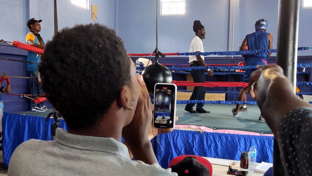 Spectators watch as young boxers take on each other in the ring at Saint Lucia boxing showcase.