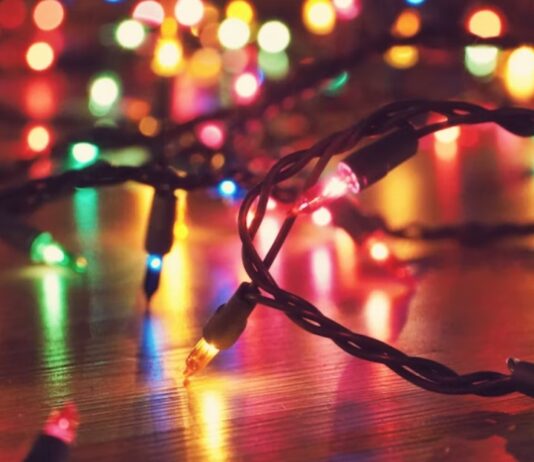 Colourful Christmas lights on a reflective floor.