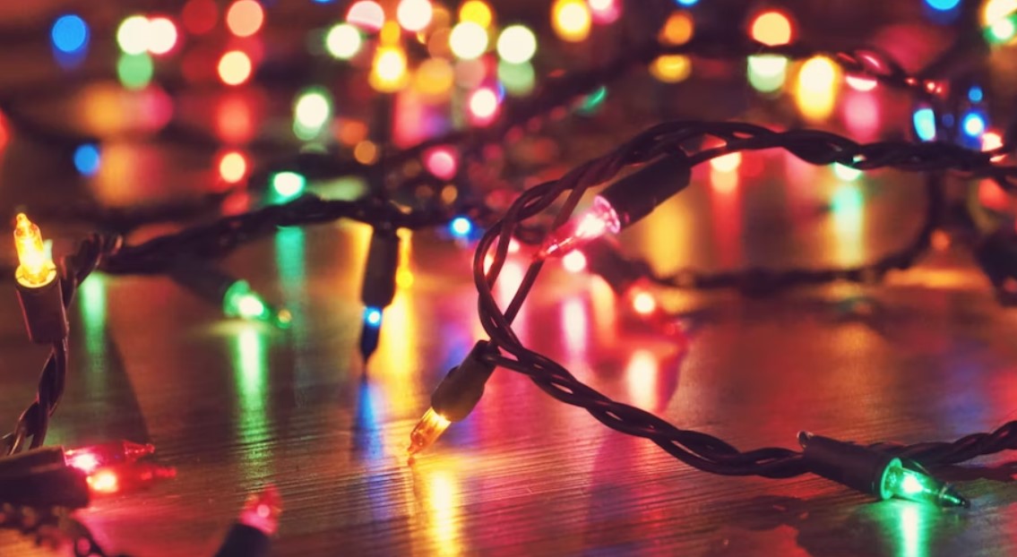 Colourful Christmas lights on a reflective floor.