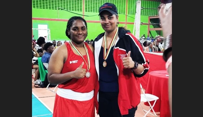 Saint Lucian light heavyweight boxer, Nikaela Khodra, left, with Trinidadian opponent, Leeann Boodram, following their February 19 bout in Georgetown, Guyana.