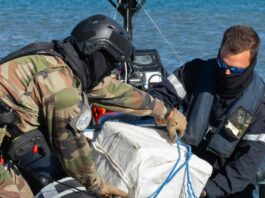 French navy crew weighs bale of cocaine.