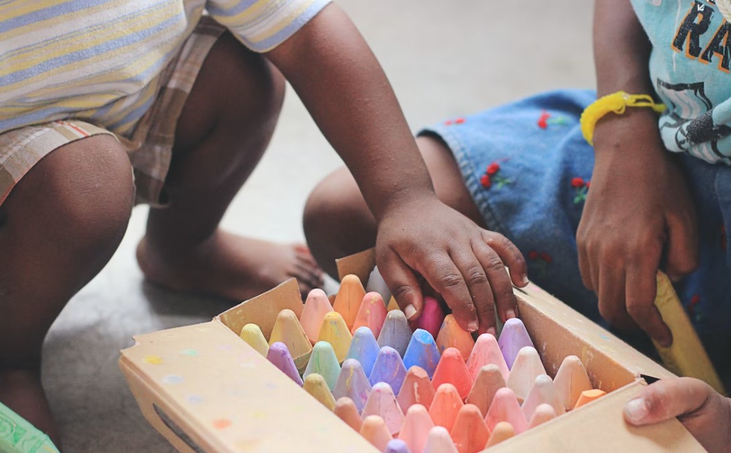 Children playing with crayons.