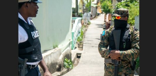 Armed police officers on patrol in Vieux Fort