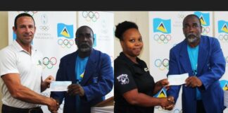 SLOC President presents cheques to two sporting associations.