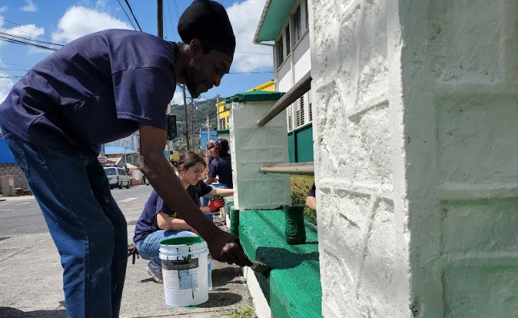 Volunteers painting the fence at the Canon Laurie Anglican Primary School in Castries.