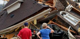 Couple surveys tornado devastation in Alabama.