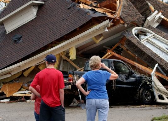 Couple surveys tornado devastation in Alabama.