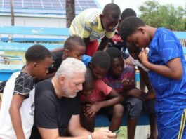 Allen Chastanet surrounded by young males during a visit to Vieux Fort.