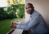 Gabriel Allahdua looks at camera as he leans over a balcony.