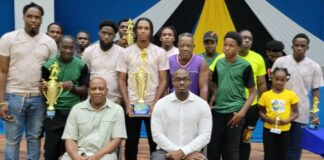 Prize winners in Gros Islet beach football competition pose with their prizes.