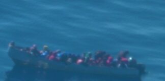 Illegal Caribbean migrants in grossly overloaded boat at sea off Puerto Rico.