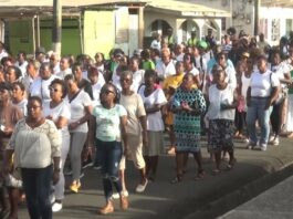 People participate in a Catholic church organised march against violence in Vieux Fort.