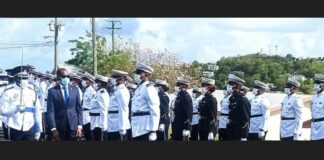 Prime Minister Philip J. Pierre inspects police guard of honour.