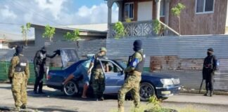 Armed police conduct traffic check in Vieux Fort