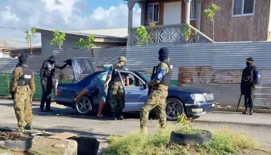 Armed police conduct traffic check in Vieux Fort