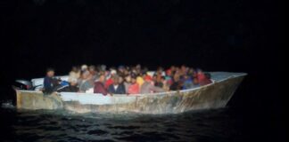 Illegal migrants aboard grossly overloaded vessel at night in waters off Puerto Rico.