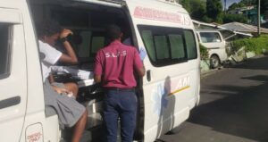 Emergency responder  attends to a student passenger.