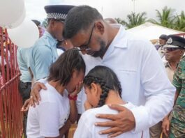 President Ali comforts grieving children after deadly school dormitory fire.