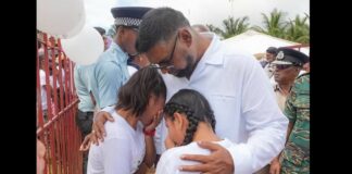 President Ali comforts grieving children after deadly school dormitory fire.