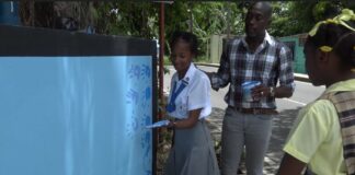 Students paint mural to highlight road safety.