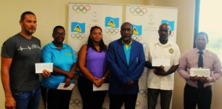PHOTO: Alfred Emmanuel, President of the St. Lucia Olympic Committee (SLOC) Inc., fourth from left, flanked by representatives from the five associations which received funding at the May 10 ceremony.