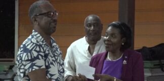 Soufriere MP Emma Hippolyte presents cheque to newly formed vendors association.