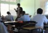Teacher stands in front of class during drug abuse prevention session.