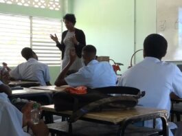 Teacher stands in front of class during drug abuse prevention session.