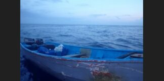 Empty wooden illegal migrant boat floats on the sea off Puerto Rico after Coast Guard officials arrest its occupants.
