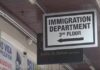 Sign with arrow pointing to the Immigration Department in Castries.
