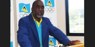 President of the St. Lucia Olympic Committee Alfred Emmanuel speaks from a podium.