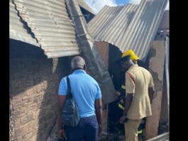 Investigators inspect charred ruins of Guyana hostel fire.