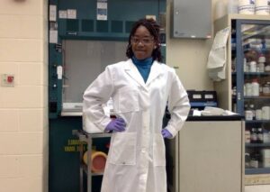 Shanan Emmanuel in white lab coat