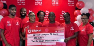 Digicel staff stand behind huge $27,000 cheque in support of special Olympics.