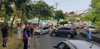 Onlookers gather at scene where two vehicles collided in Castries.
