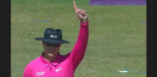 ICC cricket umpire gives raises index finger to signal that a batsman is out.