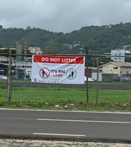 Do not litter sign on airport runway fence at Vigie.