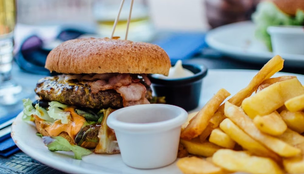 Burger and fries on a plate.