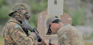 Saint Lucia police officer in combat fatigues participates in weapons training during Tradewinds 2023 in Guyana.