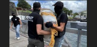 French law enforcement officers offload bales of drugs seized at sea off Martinique.