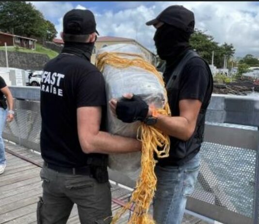 French law enforcement officers offload bales of drugs seized at sea off Martinique.