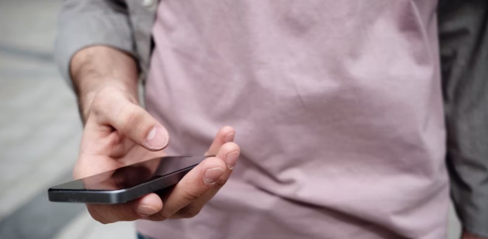 Hand texting on mobile telephone.